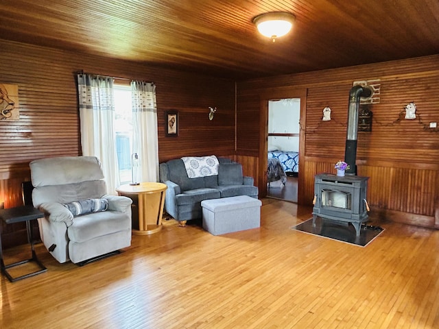 6998 River Rd, Lemington, VT 05903 - living room with wood walls, a wood stove, wood finished floors, and wood ceiling