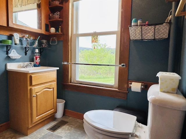 6998 River Rd, Lemington, VT 05903 - bathroom with toilet, healthy amount of natural light, vanity, and baseboards