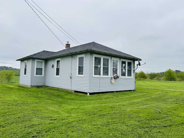 6998 River Rd, Lemington, VT 05903 - view of property exterior featuring a yard, a chimney, and a shingled roof