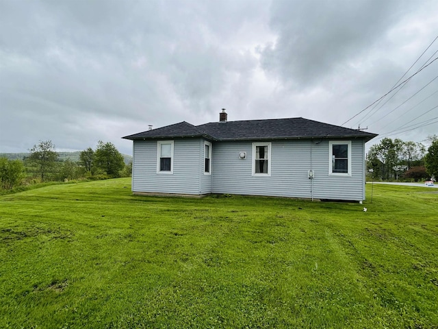 6998 River Rd, Lemington, VT 05903 - back of property with a lawn, a chimney, and roof with shingles
