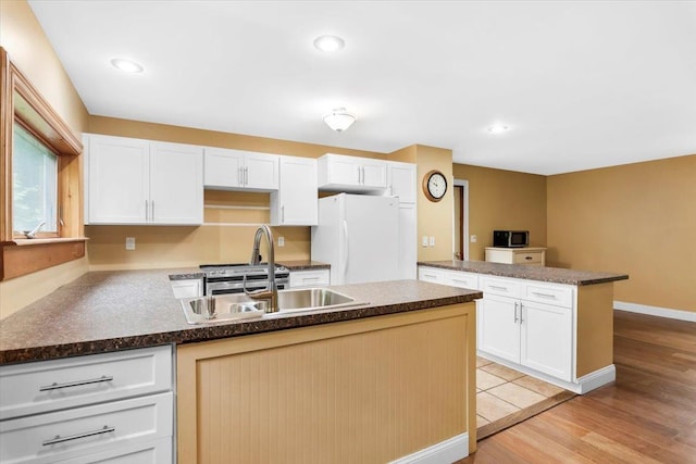 379 Swallow Hill Rd, Pownal, VT 05261 - kitchen featuring a peninsula, freestanding refrigerator, white cabinetry, and recessed lighting
