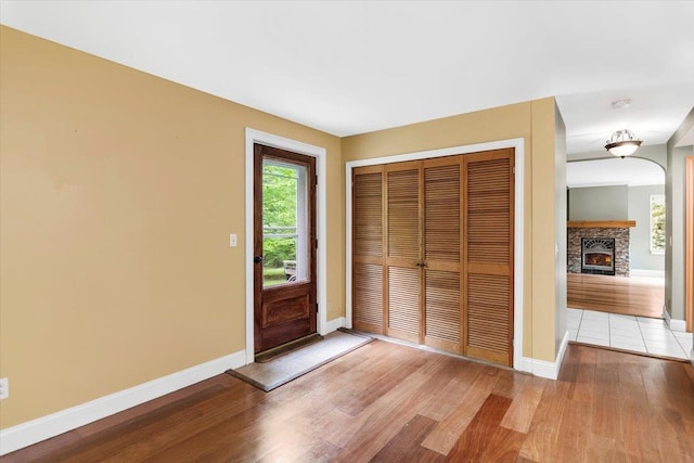 379 Swallow Hill Rd, Pownal, VT 05261 - entrance foyer with light wood-style flooring, baseboards, and a lit fireplace