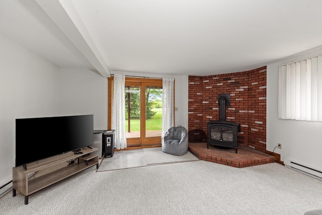 11 Village W Dr Unit 5, Bristol, NH 03222 - living area featuring a wood stove, a baseboard radiator, and carpet flooring