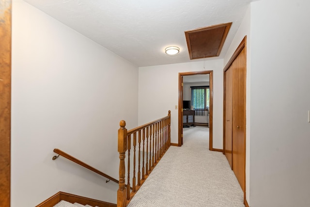 11 Village W Dr Unit 5, Bristol, NH 03222 - hall featuring an upstairs landing, attic access, light colored carpet, and baseboards