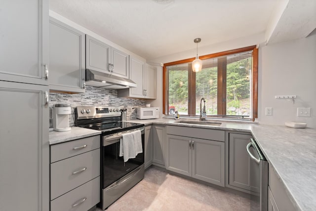 11 Village W Dr Unit 5, Bristol, NH 03222 - kitchen with appliances with stainless steel finishes, under cabinet range hood, gray cabinets, a sink, and backsplash