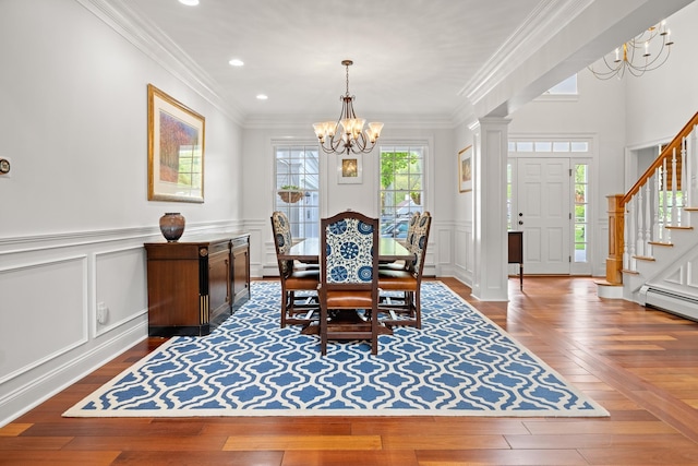 543 Lower Hollow Rd, Dorset, VT 05251 - dining room featuring a chandelier, a decorative wall, stairs, baseboard heating, and wood-type flooring