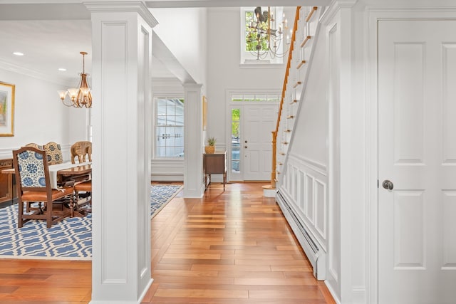 543 Lower Hollow Rd, Dorset, VT 05251 - foyer entrance featuring a chandelier, a baseboard radiator, light wood finished floors, crown molding, and recessed lighting