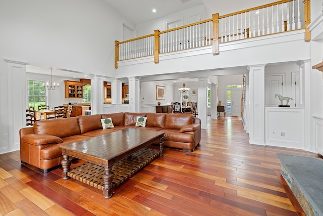 543 Lower Hollow Rd, Dorset, VT 05251 - living area with a chandelier, ornate columns, a high ceiling, light wood-type flooring, and recessed lighting