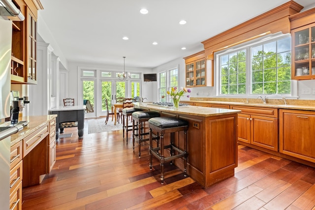 543 Lower Hollow Rd, Dorset, VT 05251 - kitchen with a center island, dark wood-style floors, a kitchen bar, recessed lighting, and brown cabinets