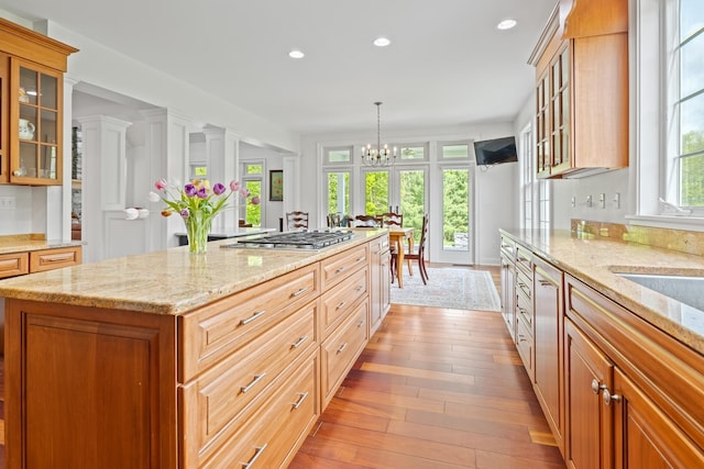 543 Lower Hollow Rd, Dorset, VT 05251 - kitchen featuring light wood-type flooring, stainless steel gas stovetop, recessed lighting, a center island, and light stone countertops