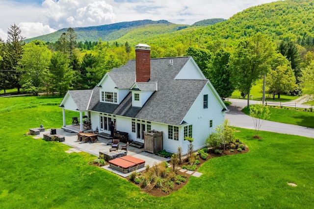 543 Lower Hollow Rd, Dorset, VT 05251 - back of property featuring a shingled roof, a forest view, and a yard