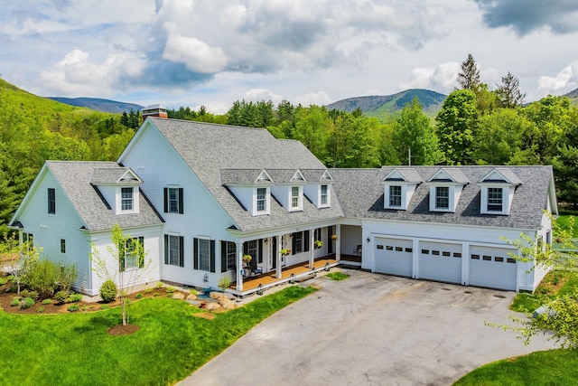 543 Lower Hollow Rd, Dorset, VT 05251 - cape cod home with driveway, a porch, a garage, a chimney, and a mountain view