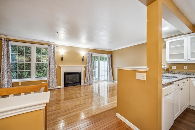 60 Barrington Ave Unit 60, Nashua, NH 03062 - unfurnished living room with a sink, hardwood / wood-style floors, a fireplace, crown molding, and baseboards