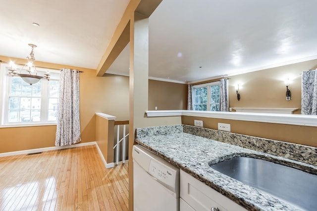 60 Barrington Ave Unit 60, Nashua, NH 03062 - kitchen with dishwasher, baseboards, white cabinets, light wood finished floors, and a sink