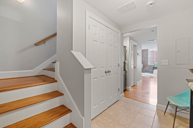 48 Landing Ln Unit 15, Laconia, NH 03246 - stairs with tile patterned floors, electric panel, and baseboards