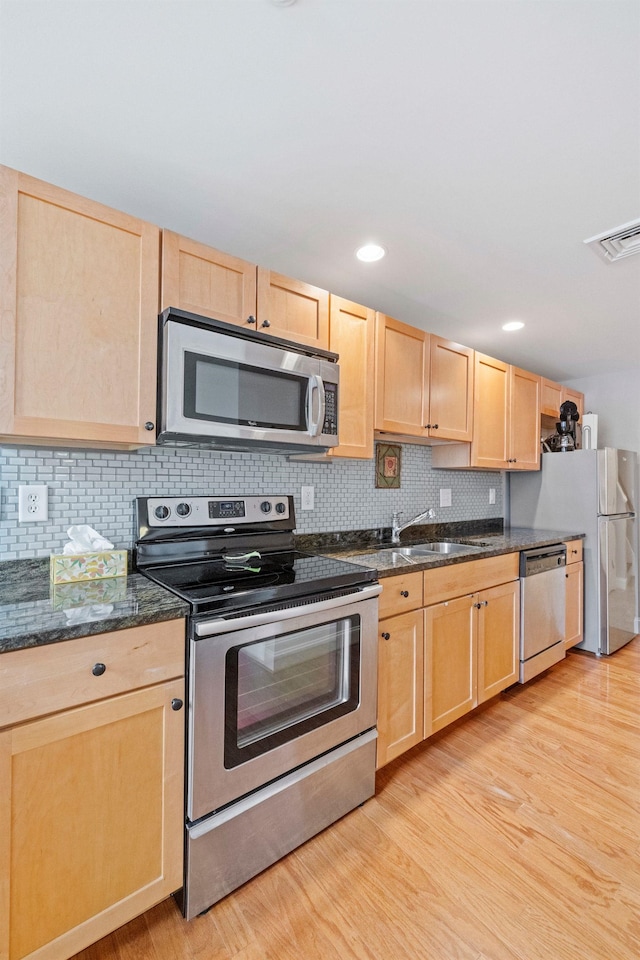 48 Landing Ln Unit 15, Laconia, NH 03246 - kitchen with stainless steel appliances, light brown cabinets, a sink, light wood finished floors, and recessed lighting