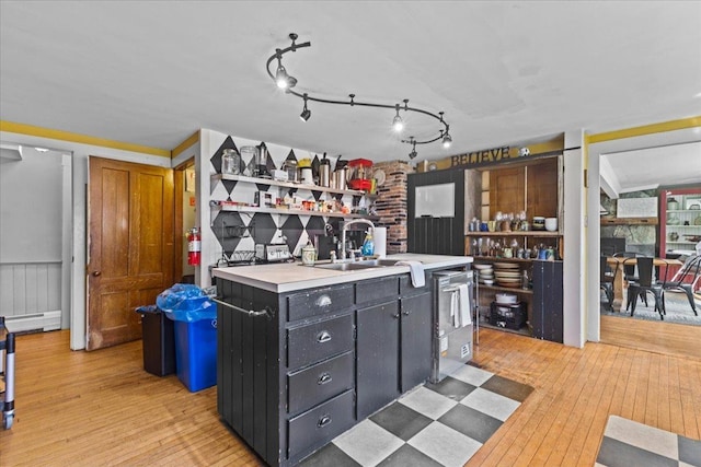 1460 Main St, Waitsfield, VT 05673 - bar area with light wood-style flooring, a sink, dishwasher, and a baseboard radiator