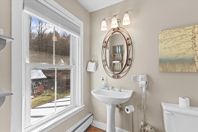 1460 Main St, Waitsfield, VT 05673 - half bath with toilet, a sink, baseboards, and wood finished floors