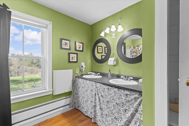1460 Main St, Waitsfield, VT 05673 - full bathroom featuring baseboard heating, healthy amount of natural light, double vanity, and wood finished floors