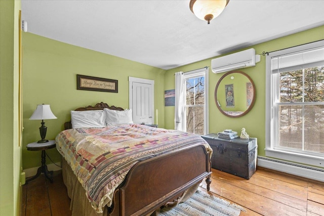 1460 Main St, Waitsfield, VT 05673 - bedroom featuring a wall mounted AC, hardwood / wood-style floors, a baseboard radiator, and baseboards