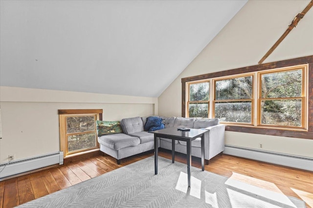 1460 Main St, Waitsfield, VT 05673 - living area with a baseboard heating unit, hardwood / wood-style flooring, vaulted ceiling, and a baseboard radiator