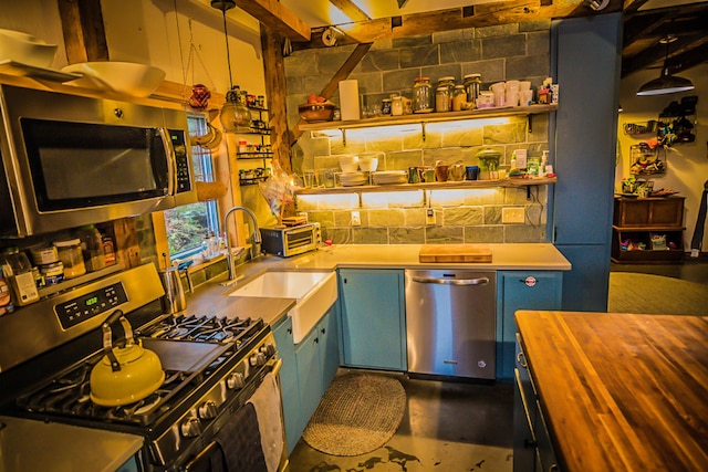1460 Main St, Waitsfield, VT 05673 - kitchen with stainless steel appliances, wood counters, concrete flooring, a sink, and blue cabinets