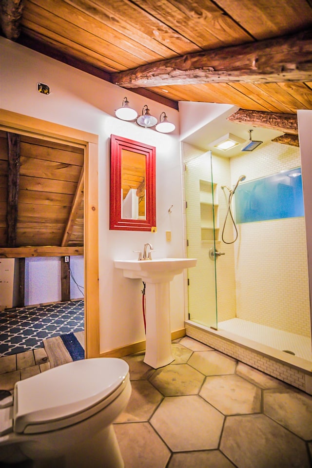 1460 Main St, Waitsfield, VT 05673 - bathroom featuring wooden ceiling with exposed beams, a shower stall, toilet, and tile patterned flooring