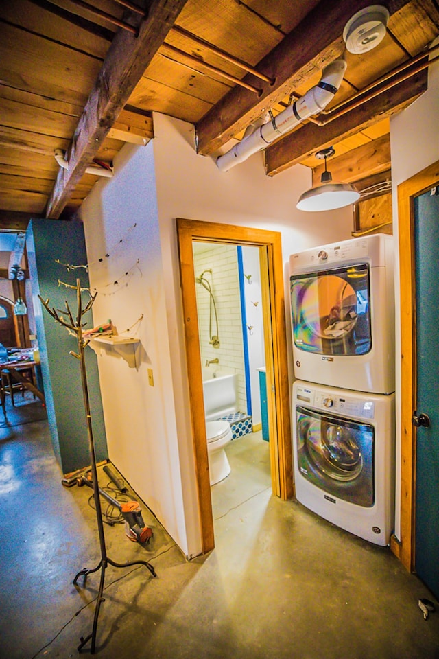 1460 Main St, Waitsfield, VT 05673 - corridor with stacked washing machine and dryer, finished concrete floors, and wood ceiling with exposed beams