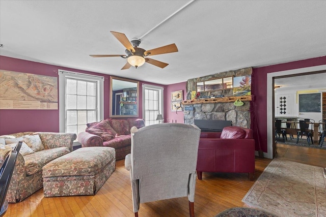 1460 Main St, Waitsfield, VT 05673 - living area featuring wood-type flooring, a ceiling fan, and a stone fireplace