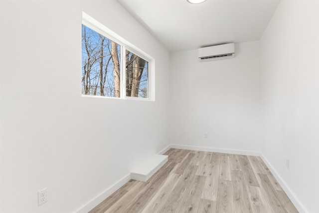 15 Highland Ave, Claremont, NH 03743 - empty room with a wall mounted air conditioner, wood finished floors, and baseboards