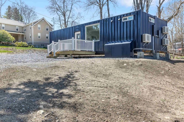 15 Highland Ave, Claremont, NH 03743 - rear view of house with a wooden deck and board and batten siding