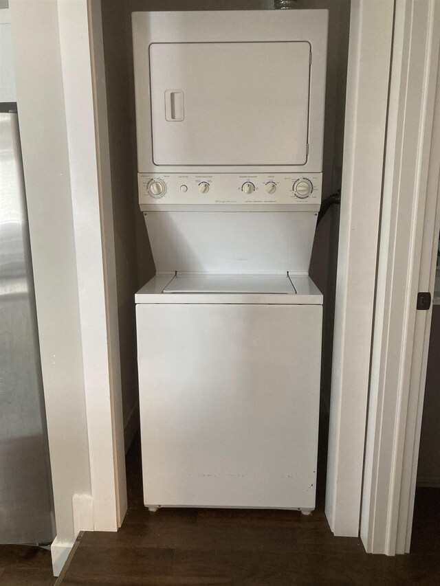 319 Main St, Montgomery, VT 05471 - laundry room with stacked washer and clothes dryer and dark wood finished floors