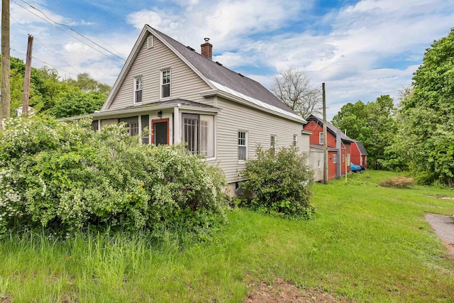 31 Prospect St, Franklin, NH 03235 - view of side of home with a chimney, a shingled roof, and a lawn