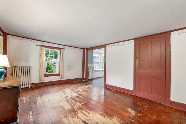 31 Prospect St, Franklin, NH 03235 - unfurnished living room featuring radiator, hardwood / wood-style floors, radiator heating unit, and baseboards