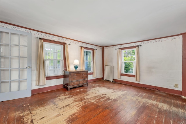 31 Prospect St, Franklin, NH 03235 - unfurnished room featuring radiator heating unit, wood-type flooring, crown molding, and baseboards