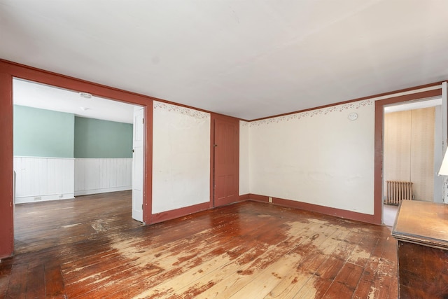 31 Prospect St, Franklin, NH 03235 - unfurnished room with radiator heating unit and hardwood / wood-style flooring