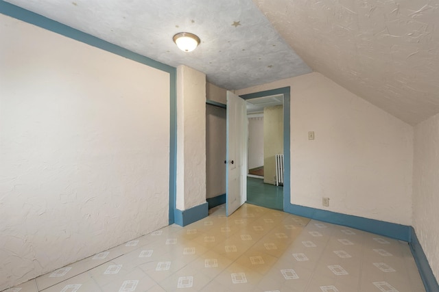 31 Prospect St, Franklin, NH 03235 - bonus room featuring lofted ceiling, radiator heating unit, and tile patterned floors