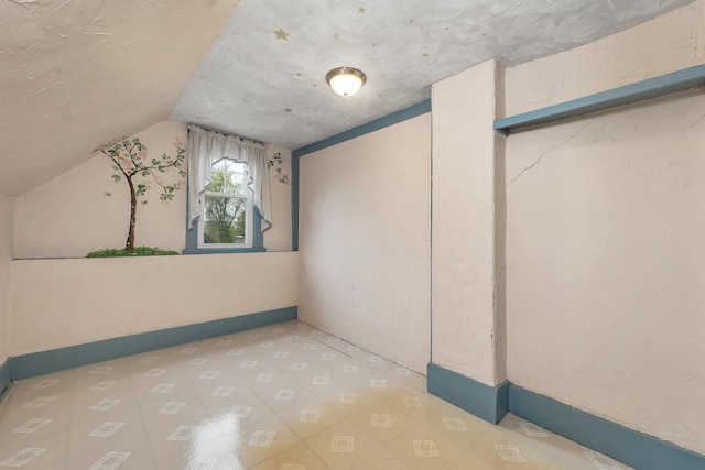 31 Prospect St, Franklin, NH 03235 - bonus room with vaulted ceiling, tile patterned floors, and baseboards