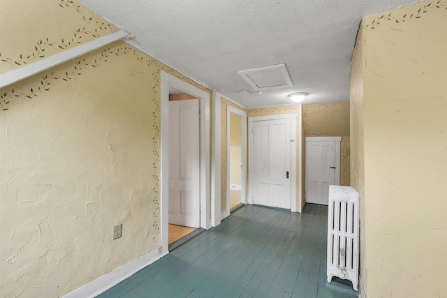 31 Prospect St, Franklin, NH 03235 - hallway featuring attic access, a textured ceiling, dark wood finished floors, baseboards, and a textured wall