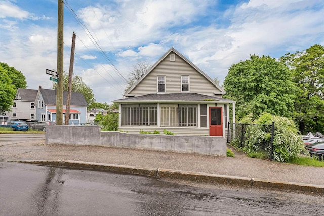 31 Prospect St, Franklin, NH 03235 - view of front of property with a sunroom and a shingled roof