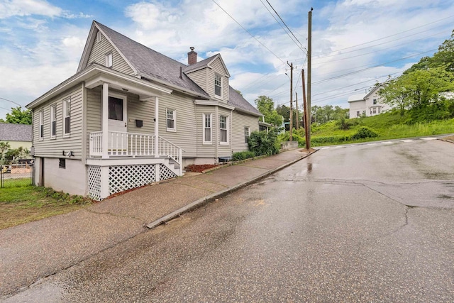 31 Prospect St, Franklin, NH 03235 - view of side of property featuring a shingled roof and a chimney