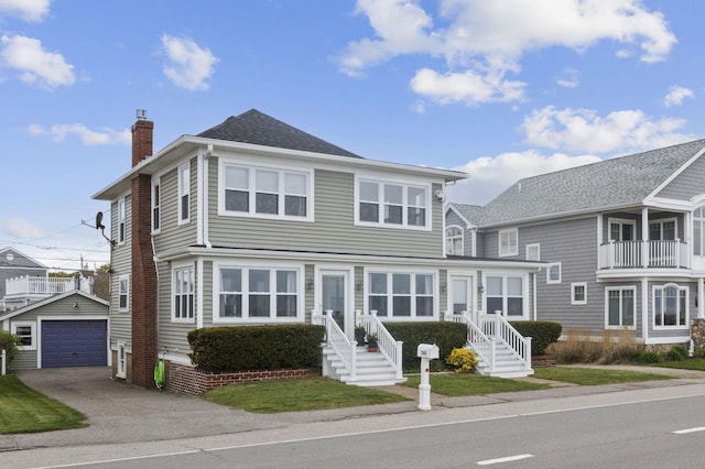 745 Ocean Blvd, Hampton, NH 03842 - view of front facade featuring an outdoor structure, a chimney, asphalt driveway, and a detached garage