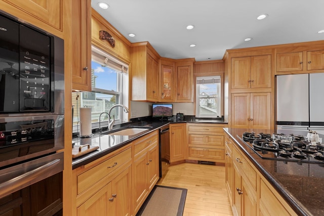 745 Ocean Blvd, Hampton, NH 03842 - kitchen with a sink, black appliances, recessed lighting, light wood finished floors, and dark stone countertops