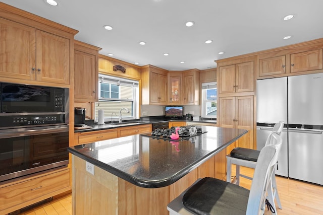 745 Ocean Blvd, Hampton, NH 03842 - kitchen featuring black appliances, a sink, a center island, light wood finished floors, and recessed lighting