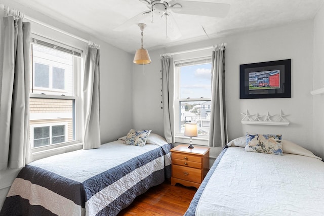 745 Ocean Blvd, Hampton, NH 03842 - bedroom featuring multiple windows, dark wood-type flooring, and ceiling fan