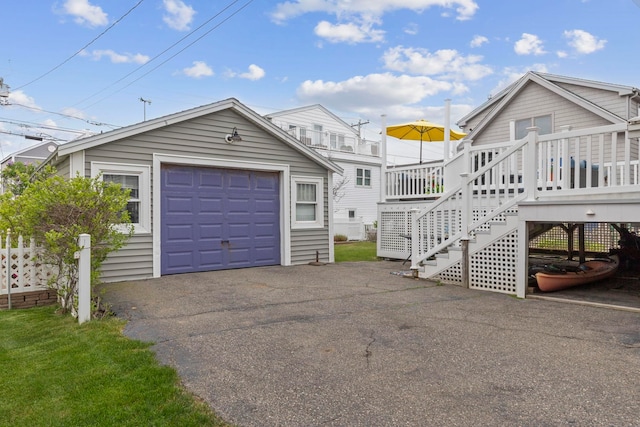 745 Ocean Blvd, Hampton, NH 03842 - view of front facade featuring an outdoor structure, a garage, driveway, stairway, and a wooden deck