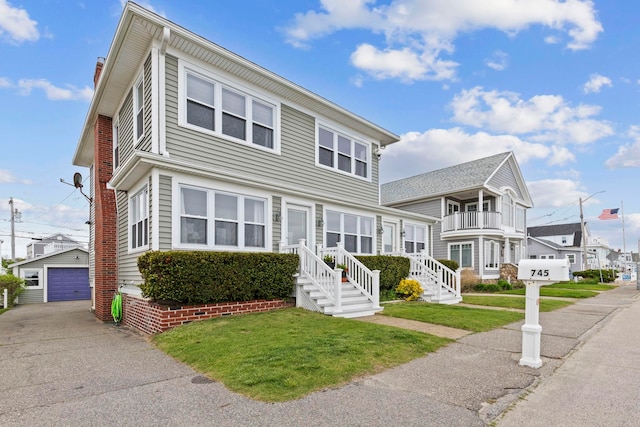 745 Ocean Blvd, Hampton, NH 03842 - view of front of property with an outdoor structure, a front yard, and a detached garage
