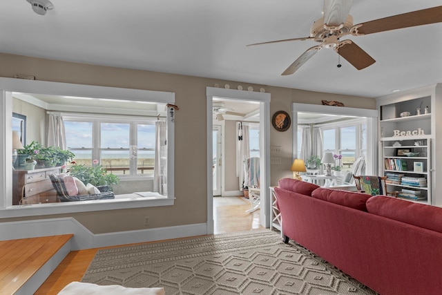 745 Ocean Blvd, Hampton, NH 03842 - living area with a ceiling fan, healthy amount of natural light, wood finished floors, and baseboards