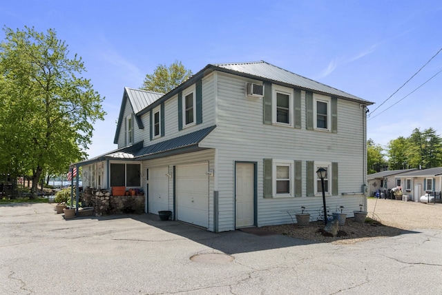 556 Weirs Blvd Unit 6, Laconia, NH 03246 - view of front of home with a garage, metal roof, driveway, and an AC wall unit