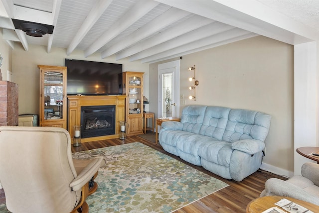556 Weirs Blvd Unit 6, Laconia, NH 03246 - living room with a glass covered fireplace, wood finished floors, beam ceiling, and baseboards